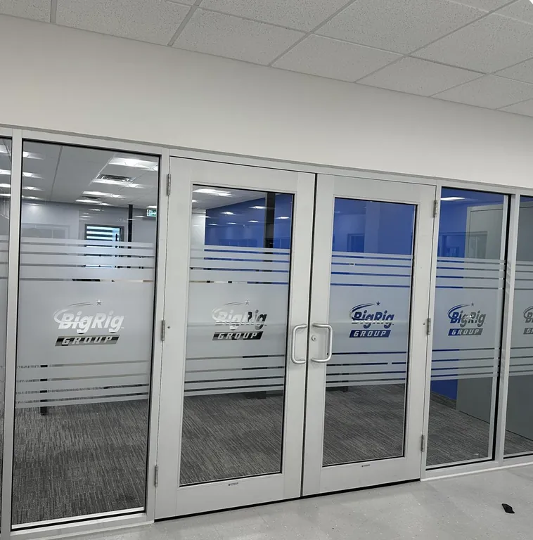 Perforated window vinyl graphics installed on a retail storefront